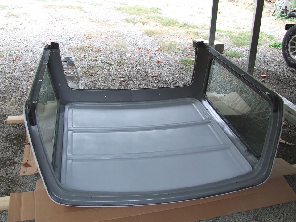 Refinished removable hardtop upside down on cardboard showing gray ribbed inner roof