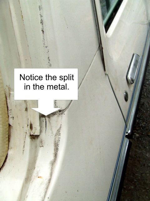 1979 Ford Bronco - A close-up view of a damaged vehicle door frame highlights a split in the metal.