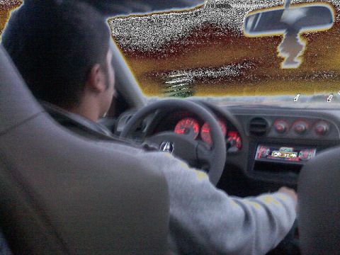 1996 Ford Probe - Driver's perspective inside a car, showing the dashboard, steering wheel, and illuminated gauges.