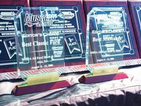 2001 Mercury Grand Marquis - Photograph of glass car-show award trophies, not a technical document.