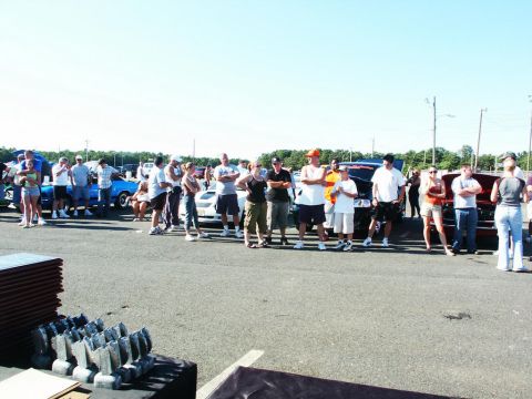 2001 Mercury Grand Marquis - A crowd of people stand around various cars at an outdoor event.