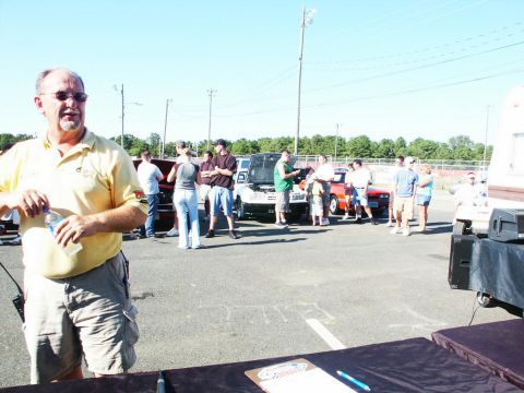 2001 Mercury Grand Marquis - A car show event is underway with attendees observing various vehicles on display.