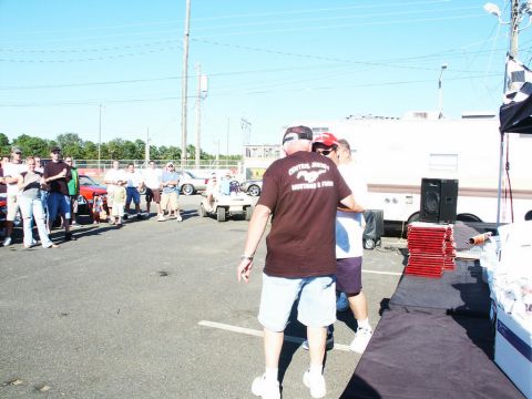 2001 Mercury Grand Marquis - Outdoor car show scene with multiple vehicles and attendees under a clear blue sky.