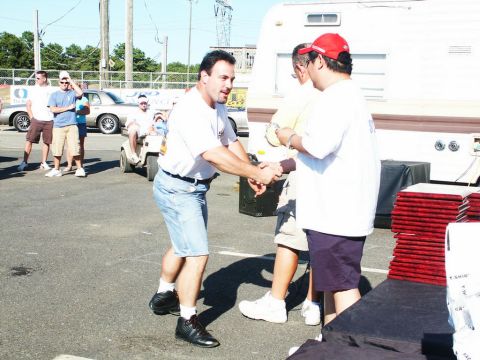 2001 Mercury Grand Marquis - A car show event with people interacting and vehicles present.