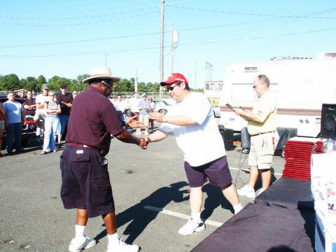 2001 Mercury Grand Marquis - People gather at an outdoor car show event with an RV visible in the background.
