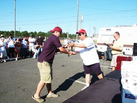 2001 Mercury Grand Marquis - An award is presented at an outdoor car show event with spectators and vehicles present.