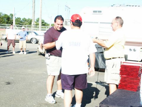 2001 Mercury Grand Marquis - A silver 2001 Mercury Grand Marquis is visible behind people gathered at an outdoor event.