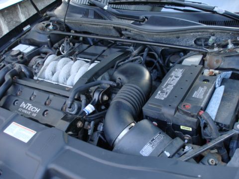 1997 Ford Crown Victoria - The engine bay shows an "InTech 32 Valve V8" engine, battery, and air intake system.