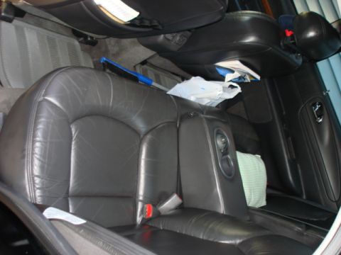 1997 Ford Crown Victoria - The interior view shows the rear leather seats, complete with an armrest and integrated cup holders.