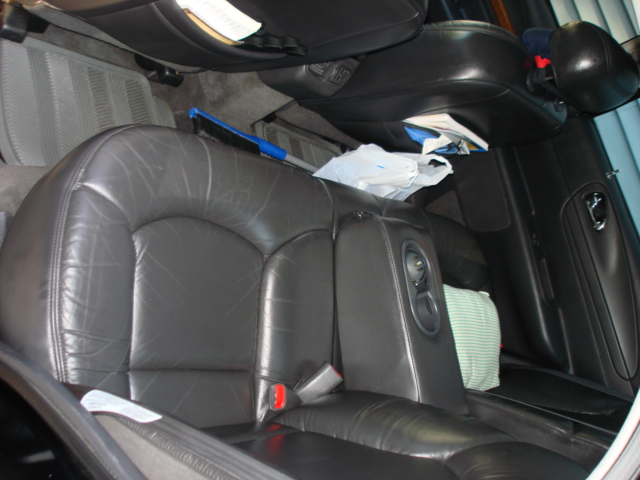 Interior rear leather seats with armrest and cup holders