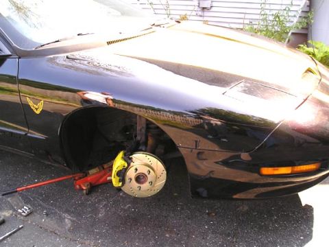 1994 Pontiac Trans Am - Working on the front brakes of a black 1994 Pontiac Trans Am, showing the upgraded caliper and rotor.