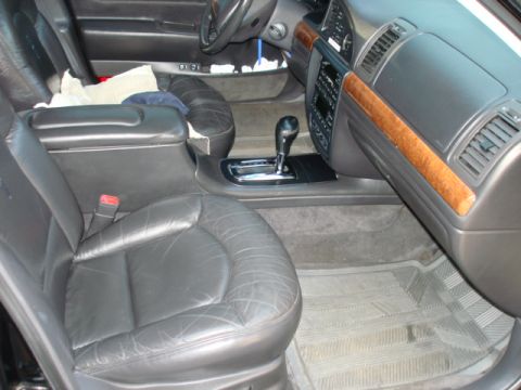 1997 Ford Crown Victoria - Interior view of a car's passenger side, showing leather seats and dashboard details.
