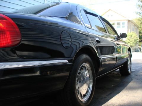 1997 Ford Crown Victoria - Rear quarter panel view of a black 1997 Ford Crown Victoria sedan.