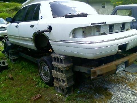 2002 Ford Crown Victoria - This 2002 Ford Crown Victoria is elevated on cinder blocks for repairs.