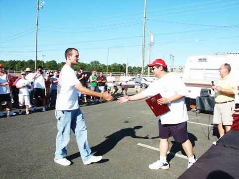 2001 Mercury Grand Marquis - Award ceremony at a car show with spectators and vehicles present.