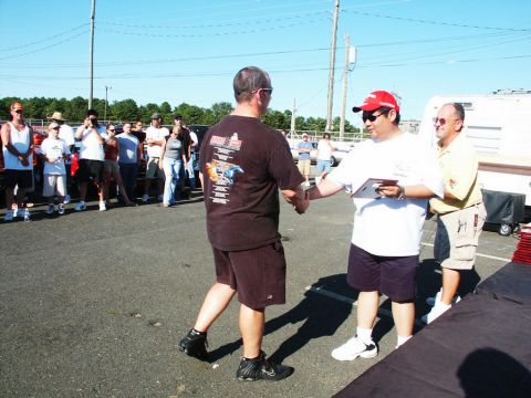 2001 Mercury Grand Marquis - Attendees gather at a car show, with one individual being presented with an award.