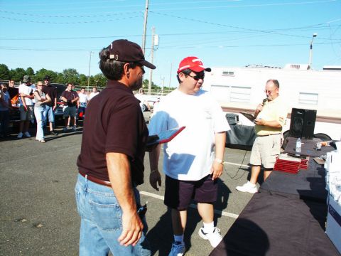 2001 Mercury Grand Marquis - An outdoor event with people and vehicles, possibly a car show.