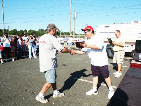 2001 Mercury Grand Marquis - Award presentation at a car show with spectators and vehicles visible.