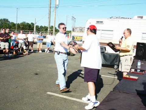 2001 Mercury Grand Marquis - An outdoor event with people interacting and a trailer visible in the background.