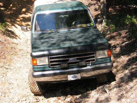 1990 Ford Bronco - This 1990 Ford Bronco navigates a challenging off-road path with its 4x4 capabilities.