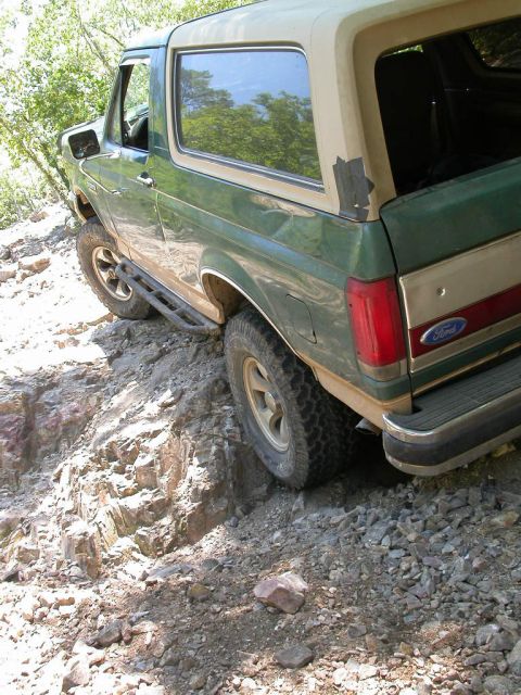 1990 Ford Bronco - This 1990 Ford Bronco is navigating a challenging rocky terrain, its off-road capabilities.