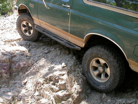 1990 Ford Bronco - This 1990 Ford Bronco navigates a challenging rocky path, its off-road capabilities.