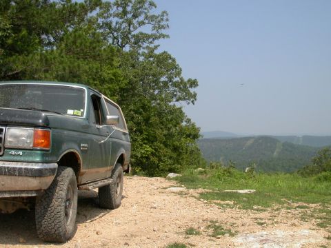1990 Ford Bronco - 1990 Ford Bronco parked at a scenic overlook on a sunny day.