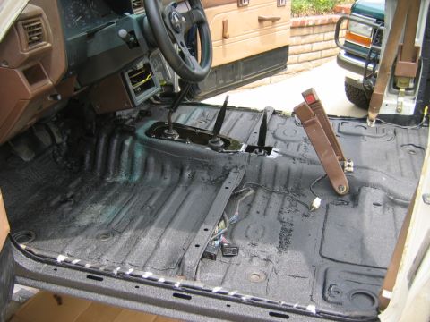 1985 Toyota 4Runner - The interior of a 1985 Toyota 4Runner is shown with the floor stripped and coated, revealing the transmission tunnel and dashboard componen…