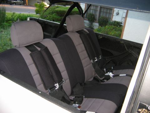 1985 Toyota 4Runner - The interior features two-tone gray and black seats equipped with racing-style seat belts.