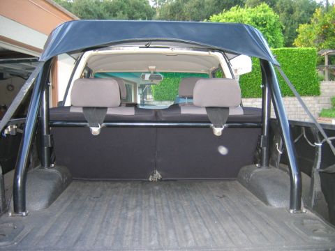 1985 Toyota 4Runner - Interior view of a 1985 Toyota 4Runner, focusing on the rear seats and roll cage.