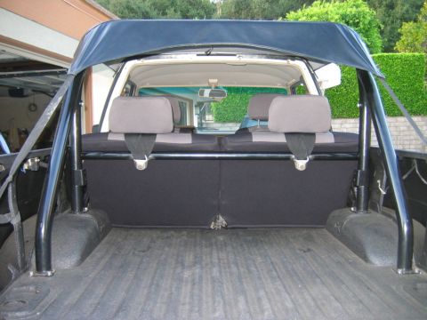 1985 Toyota 4Runner - View of the rear interior and cargo area of an SUV, showing the seats and roll bar.