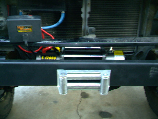 Front bumper with a winch mounted, showing wiring and roller fairlead