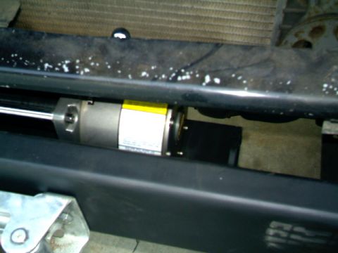 1989 Ford Bronco - Close-up view of a vehicle's front bumper area, showing a mounted cylinder with a label.