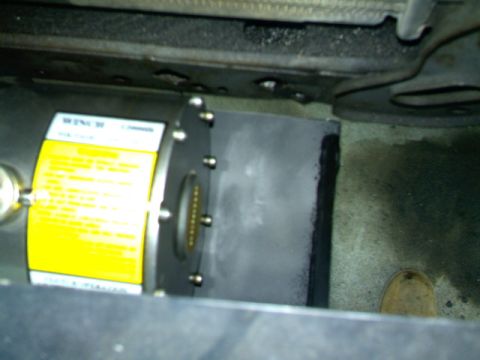 1989 Ford Bronco - Close-up of a winch unit, possibly for off-road use, with a prominent yellow warning label.
