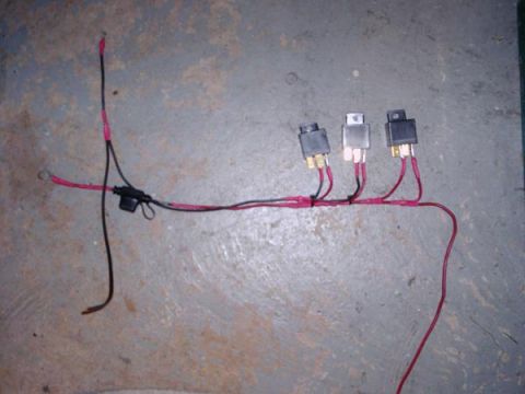 1984 Ford Bronco - A custom headlight rewire harness three relays and a fuse holder is laid out on a concrete floor.