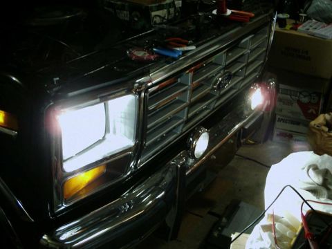 1984 Ford Bronco - Close-up of a Ford truck's front end, showing the grille and headlight assembly.