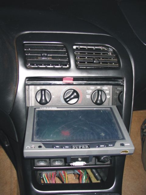 1993 Ford Probe - Interior center dashboard of a car showing black climate control knobs (fan, temperature, and vent selection dials with VENT/OFF/FLOOR/MIX…