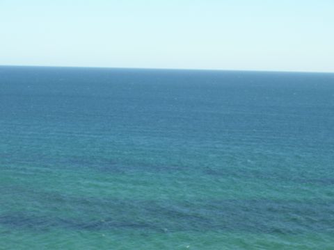 1991 Ford Bronco - The image shows a wide expanse of the ocean, with no vehicles visible.
