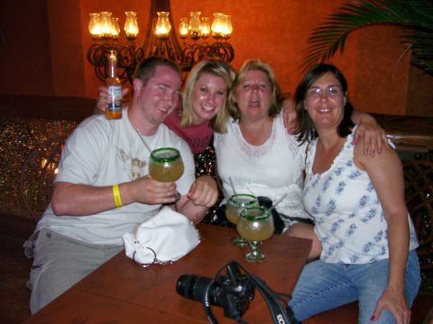 1991 Ford Bronco - A group of friends enjoys drinks and company at a table, with a camera present.