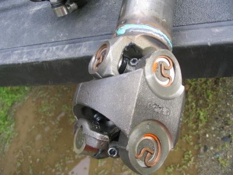 1978 Ford Bronco - Close-up of a driveshaft universal joint, showing its metal components and seals.