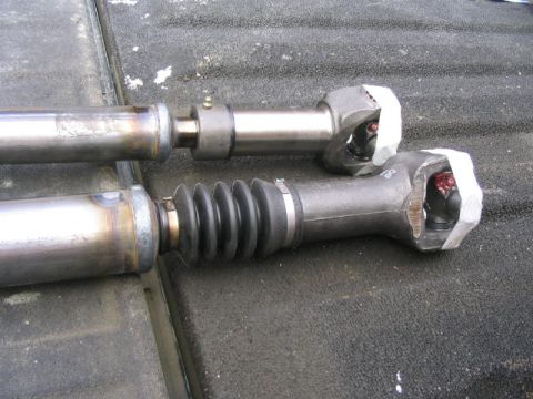 1978 Ford Bronco - Close-up of two driveshafts, one a protective rubber boot.
