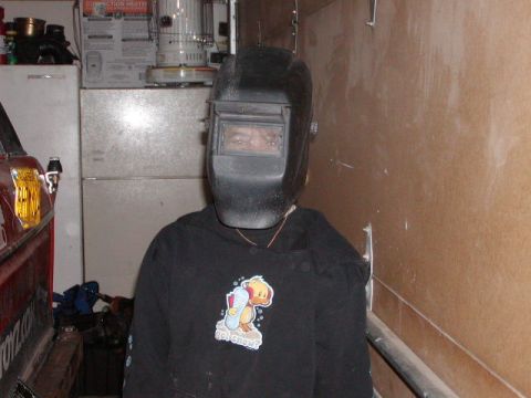 1978 Ford Bronco - A person is shown wearing a welding mask and a sweatshirt with a cartoon duck graphic.