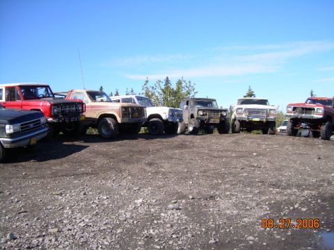 1978 Ford Bronco - A collection of off-road vehicles are parked together on a sunny day.