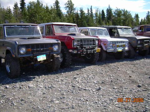 1978 Ford Bronco - A line of Ford Broncos are parked on a gravel lot with trees in the background. The date 08.27.2006 is visible.