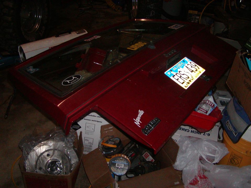 Red tailgate with Alaska license plate ERS 439 and "Naperville" badge