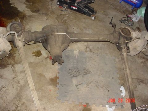 1978 Ford Bronco - Rear axle assembly, likely from a Ford truck or SUV, sits on a garage floor.