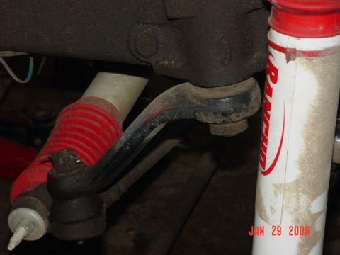 1978 Ford Bronco - Close-up view of vehicle suspension parts, including a steering linkage and a shock absorber with a date stamp.