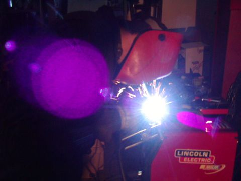 1978 Ford Bronco - A welding machine is in operation, creating a bright light and sparks.