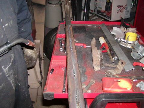 1978 Ford Bronco - Welding a metal part on a workbench with tools and a tire visible.