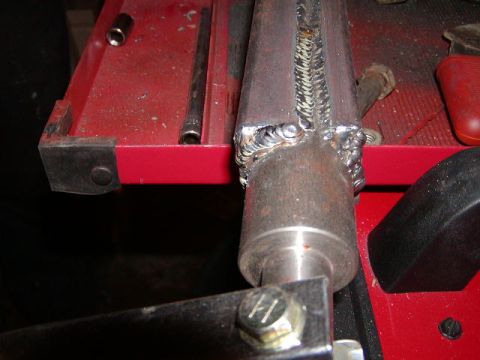 1978 Ford Bronco - A close-up view of a metal shaft with extensive welding, resting on a red toolbox.